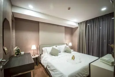 Luxurious bedroom with elegant decor and ambient lighting, perfect for relaxation and comfort.