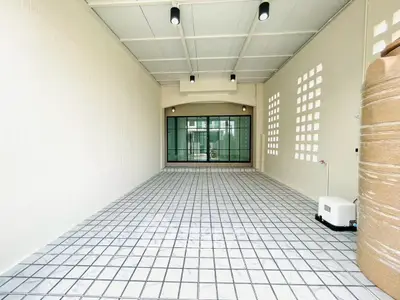 Spacious tiled garage with modern lighting and large glass doors.