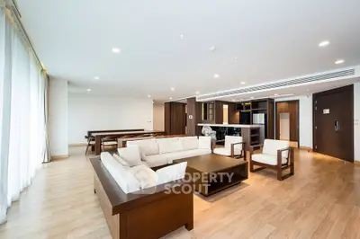 Spacious modern living room with elegant wooden furniture and open layout, perfect for entertaining.