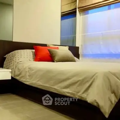 Cozy bedroom with modern decor and large windows