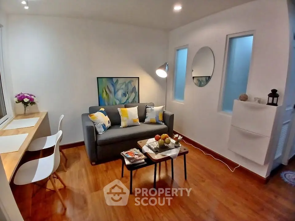 Charming living room with modern decor, cozy sofa, and stylish wooden flooring, perfect for relaxation and entertaining.