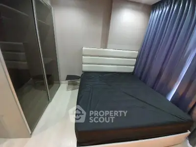 Modern bedroom with sleek design and large wardrobe, featuring elegant curtains and stylish bed.