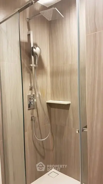 Modern bathroom shower with sleek glass enclosure and elegant tile design
