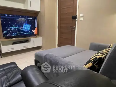 Cozy living room with modern entertainment setup and plush seating