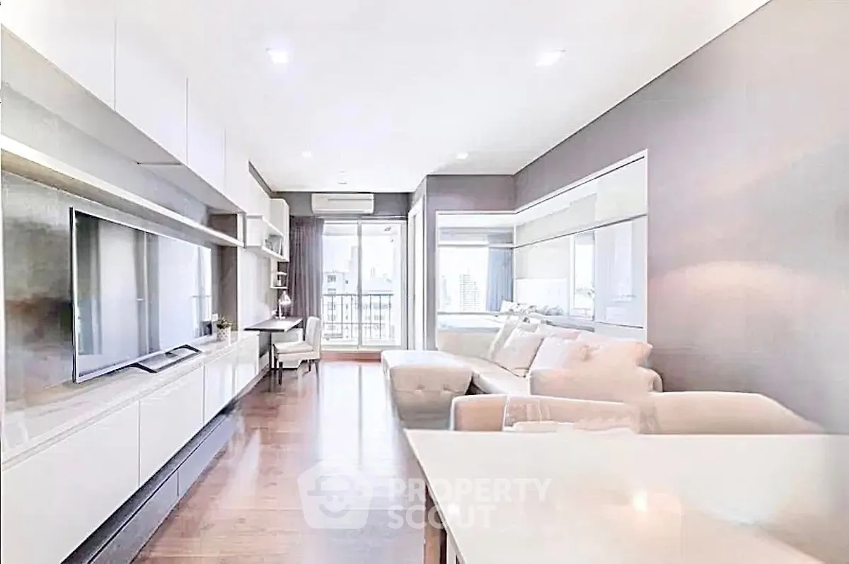 Spacious modern living room with sleek design and large windows offering natural light.