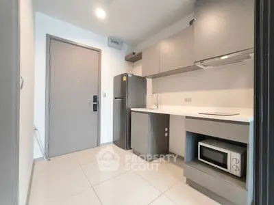 Modern kitchen with sleek cabinetry and appliances in a compact layout.