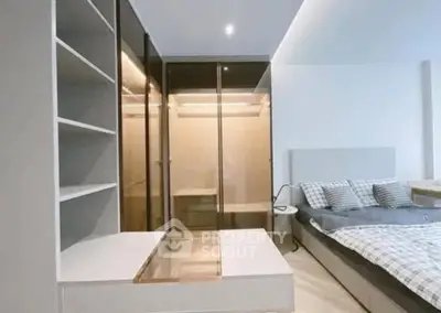 Modern bedroom with sleek design and built-in storage solutions.