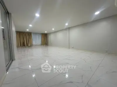 Spacious modern living room with marble flooring and large windows