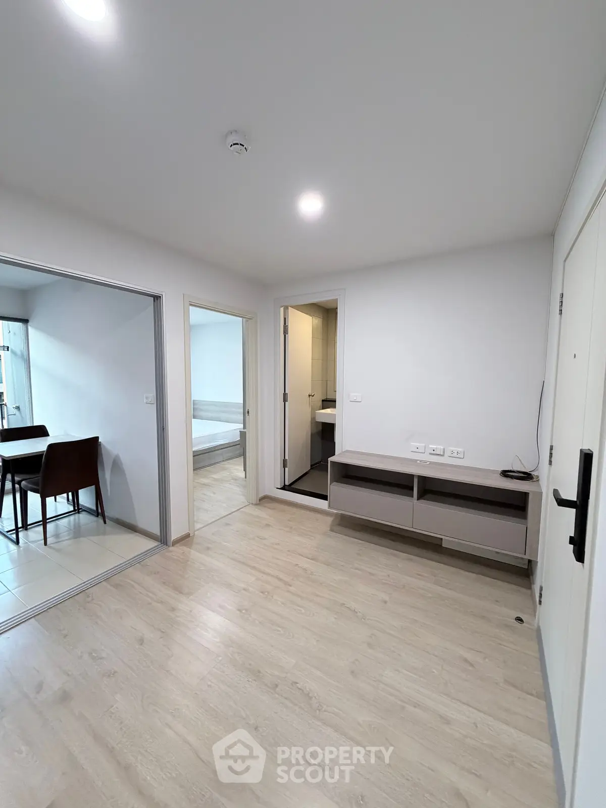 Modern apartment interior with open layout and light wood flooring