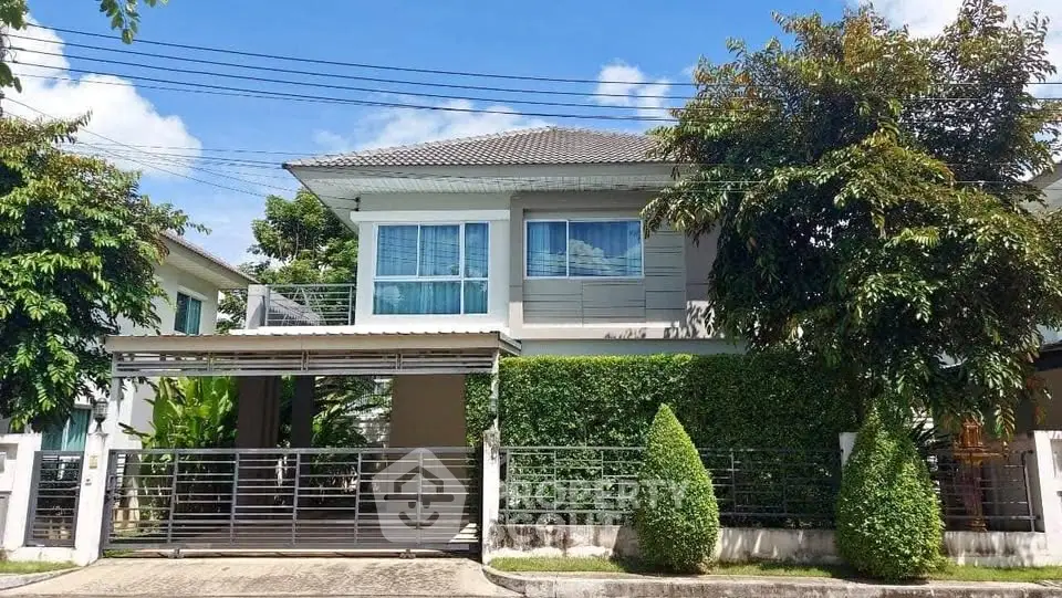 Charming two-story house with lush greenery and modern design in a serene neighborhood.