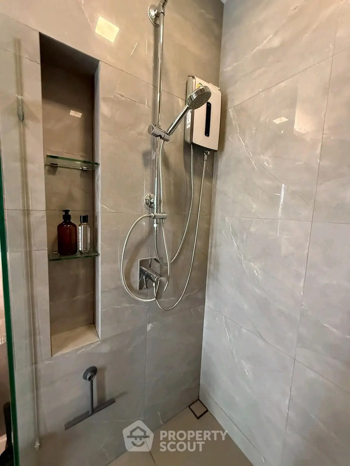 Modern bathroom shower with sleek tiles and built-in shelving