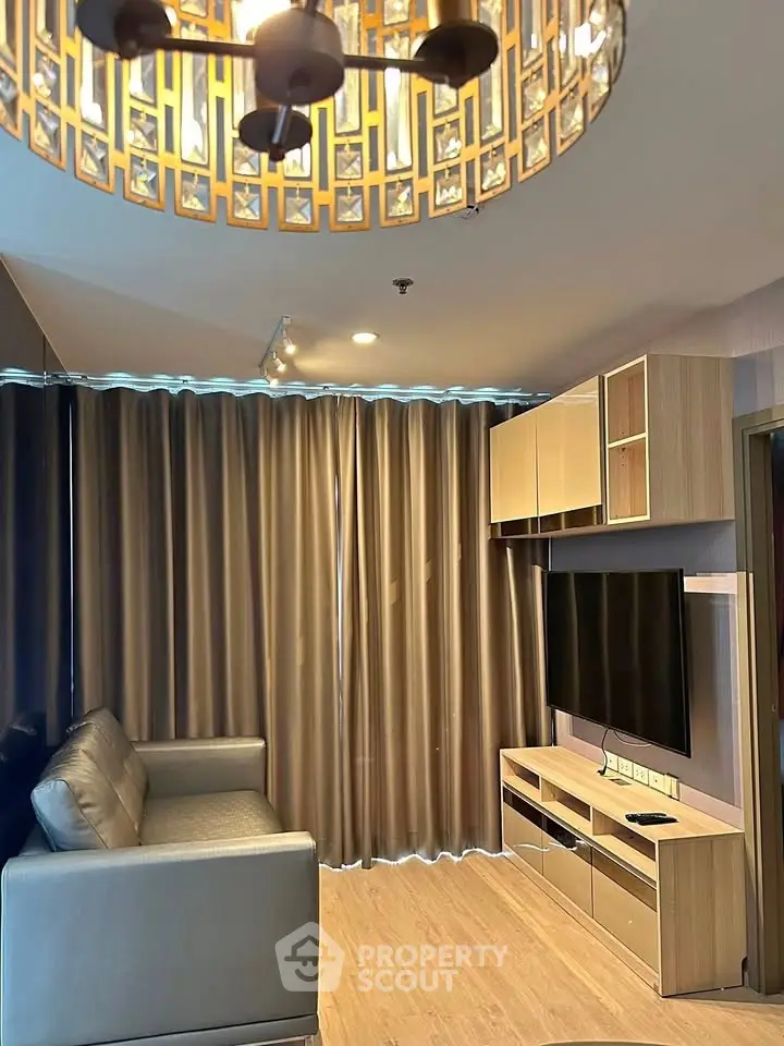 Modern living room with stylish chandelier and sleek furniture