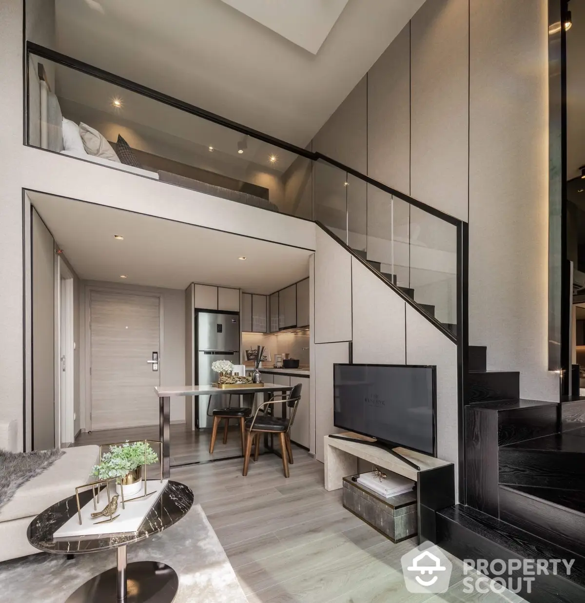 Chic urban loft featuring high ceilings, modern kitchen with stainless steel appliances, and a sleek staircase leading to a cozy mezzanine level.