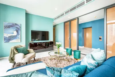 Luxurious modern living room with vibrant teal accents and elegant decor