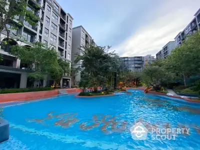 Luxurious residential complex with stunning pool and lush greenery