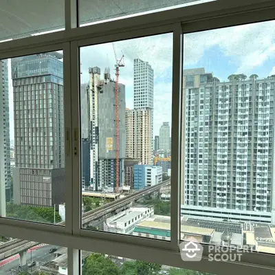 Stunning cityscape view from high-rise apartment window showcasing urban skyline.