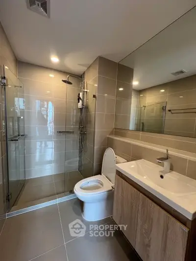Modern bathroom with sleek design, glass shower, and contemporary fixtures.