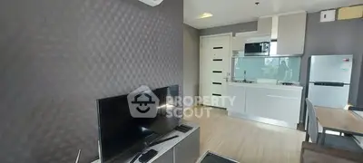 Modern living room with sleek kitchen and stylish decor