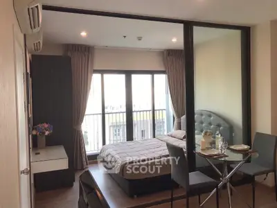 Modern studio apartment with glass partition and balcony view