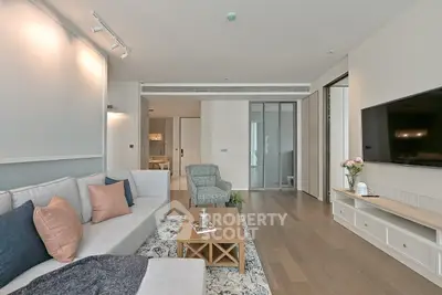 Spacious modern living room with elegant decor and large TV