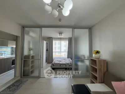 Modern apartment with open layout, featuring a cozy bedroom and stylish kitchen.