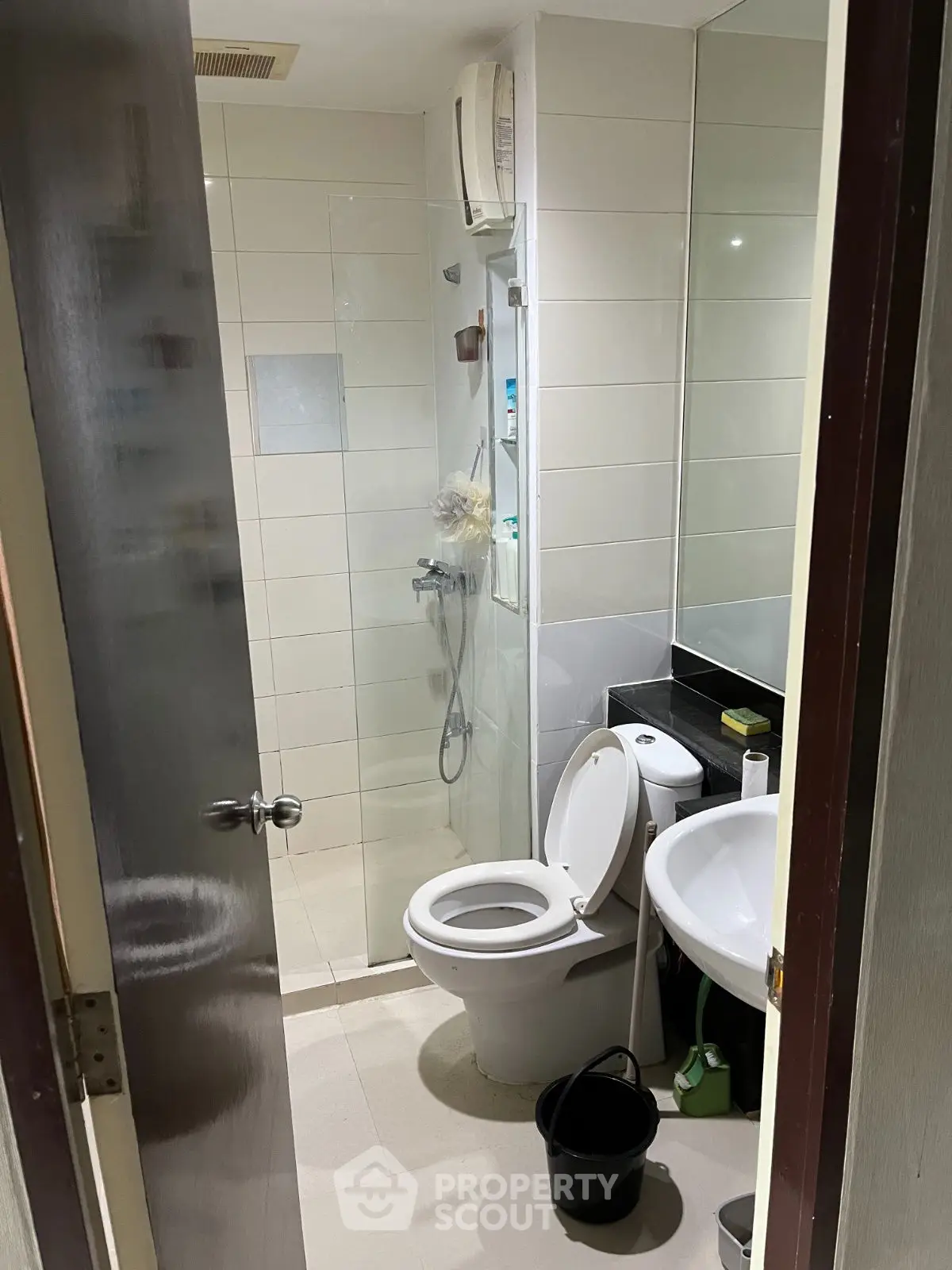 Compact bathroom with shower and modern fixtures, ideal for efficient space use.