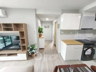 Modern open-plan living room with sleek kitchen and stylish decor
