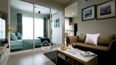 Modern living room with cozy sofa, glass partition, and stylish decor in a contemporary apartment.