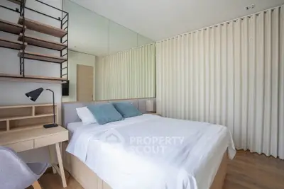 Modern bedroom with stylish decor and ample natural light