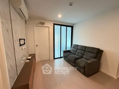 Modern living room with sleek design and comfortable seating in a stylish apartment.