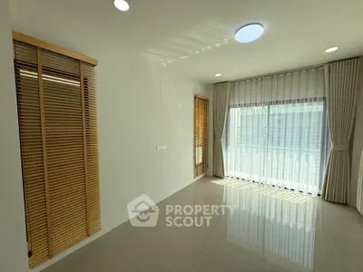 Bright and spacious room with large windows and elegant blinds, perfect for modern living.