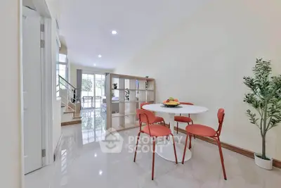 Spacious open-plan living area with modern dining set and natural light