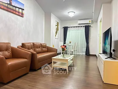 Modern living room with brown leather sofas and sleek TV setup
