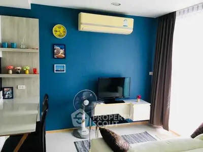 Modern living room with blue accent wall, air conditioning, and stylish decor.