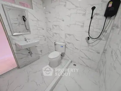 Modern bathroom with marble tiles and sleek fixtures