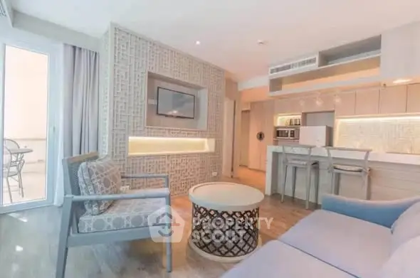 Modern living room with open kitchen and stylish decor in a bright apartment.