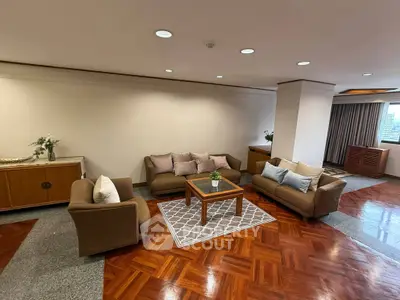 Spacious living room with elegant furniture and wooden flooring in a modern apartment.