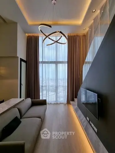Luxurious high-ceiling living room with modern lighting and panoramic city view.