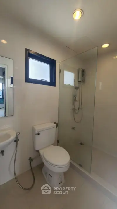 Modern bathroom with glass shower and sleek fixtures