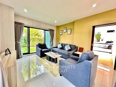 Stylish living room with modern furniture and garden view, perfect for relaxation and entertaining.