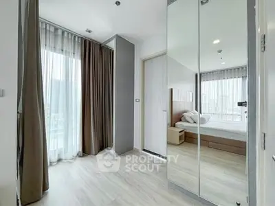 Spacious modern bedroom with floor-to-ceiling windows and elegant decor.
