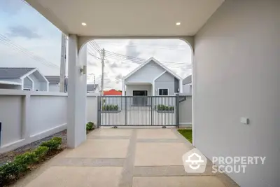 Modern house entrance with sleek design and spacious driveway