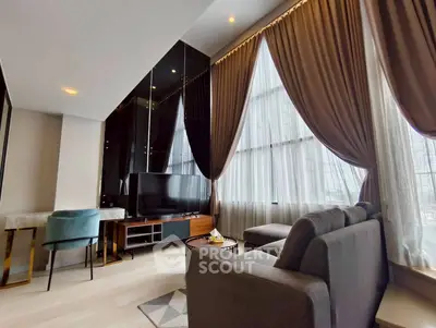 Luxurious modern living room with large windows and elegant curtains