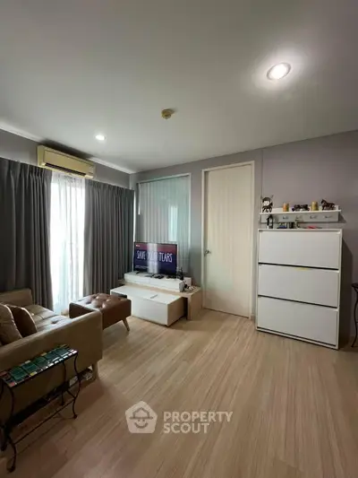 Modern living room with sleek furniture and natural light, perfect for relaxation and entertainment.