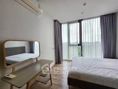 Modern bedroom with large window and stylish furniture, offering a serene and inviting atmosphere.