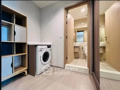 Modern apartment interior with washing machine and bathroom view