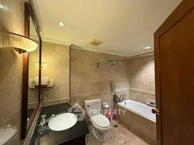 Luxurious bathroom with elegant stone tiles and modern fixtures