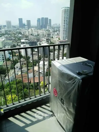 Stunning city view from high-rise balcony with modern washing machine.