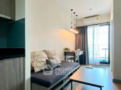 Modern living room with cozy sofa, stylish lighting, and balcony access in a chic apartment.