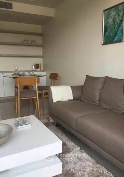 Modern living room with cozy sofa and elegant dining area, perfect for stylish urban living.